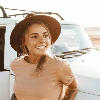 image of woman leaning on a 4wd car